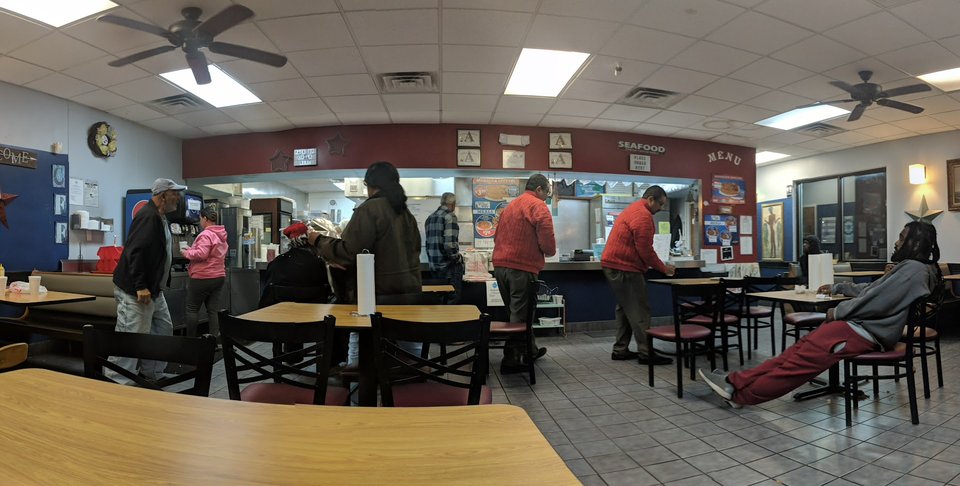 Drive-through seafood restaurant exterior with parking nearby.